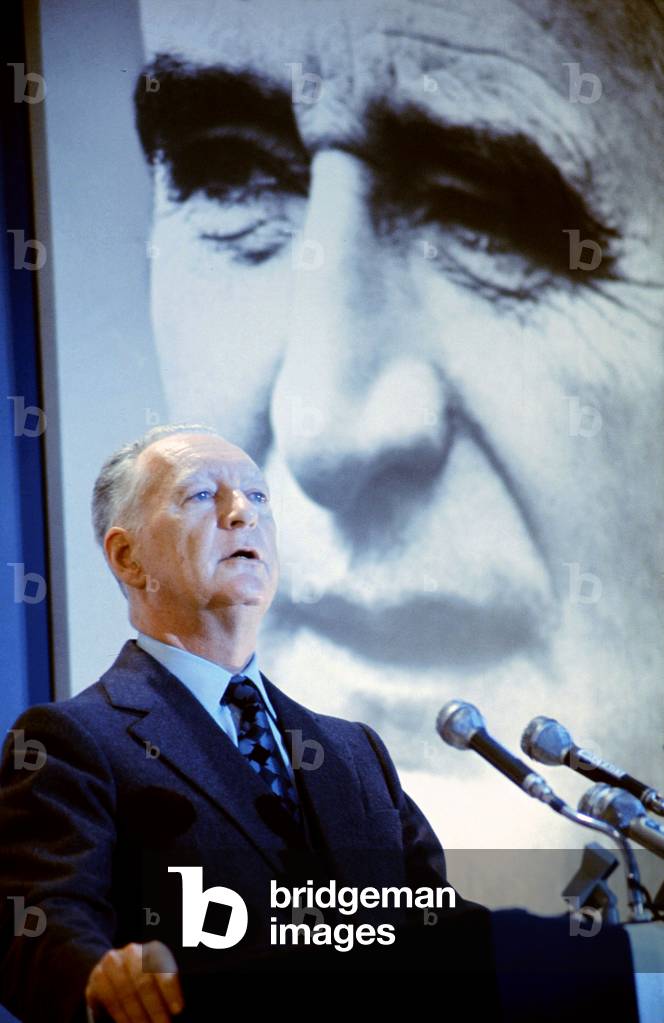 French Prime Minister Pierre Messmer Making Speech during Electoral Campaign January 8, 1973 on The Wall Portrait of Georges Pompidou (photo)