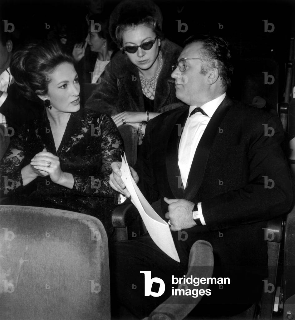 French Actor Jean Richard and his Wife at Concert of Charlesaznavour at The Olympia in Paris, 1965 (b/w photo)