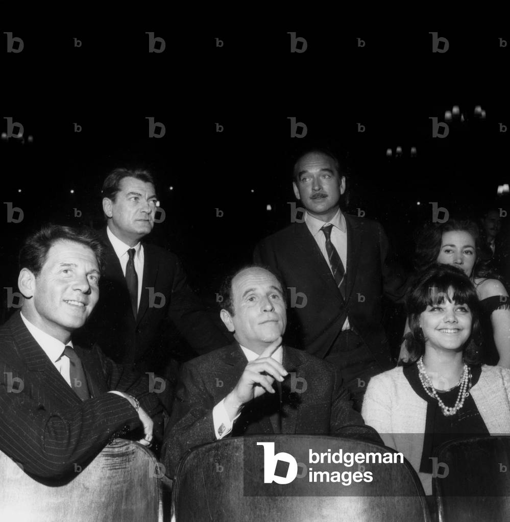 Singer Leo Ferre (C) Presenting New Record here With Jean Pierre Aumont, Jean Marais, Eddie Barclay, Claudine Coster and Tina Aumont Marquand (Daughter of Jean-Pierre Aumont) April 08, 1964 (b/w photo)