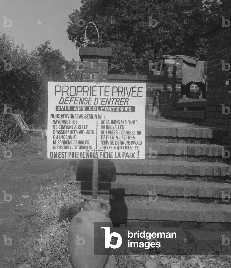 In Normandy, France, the owner of a house has put a board against pedlars, he doesn't want to be disturbed and needs nothing, September 13, 1960 (b/w photo)