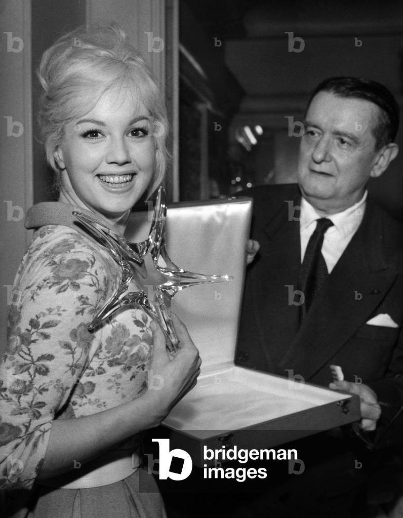 Georges Auric Gives The Etoile De Cristal Award To The French Actress Mylene Demongeot (Film 'The Crucible'). Diner at Lasserre Restaurant, December 14, 1958 (b/w photo)