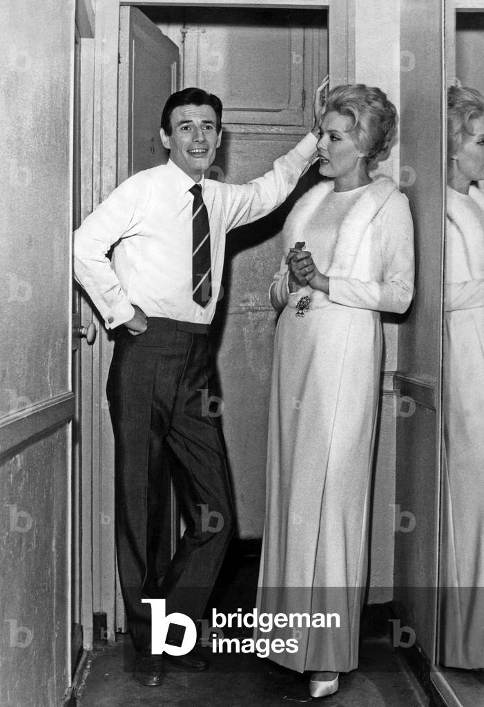French Singers Jean Ferrat and Corinne Marchand in The Backstage of Bobino For The Premiere of Their Show December 30, 1965 (b/w photo)
