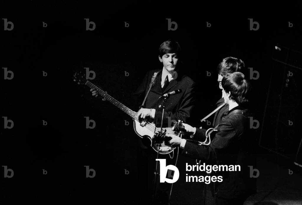 The Beatles: Paul McCartney, John Lennon and George Harrison at The Olympia in Paris, 17th January 1964 (b/w photo)