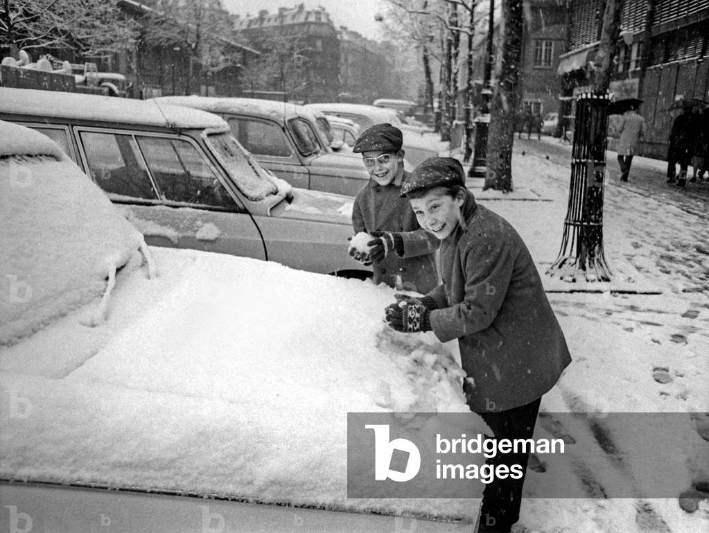 Winter in Paris, December 6, 1969 : Children Taking Snow on The Cars Probably For A Snowball Fight (b/w photo)