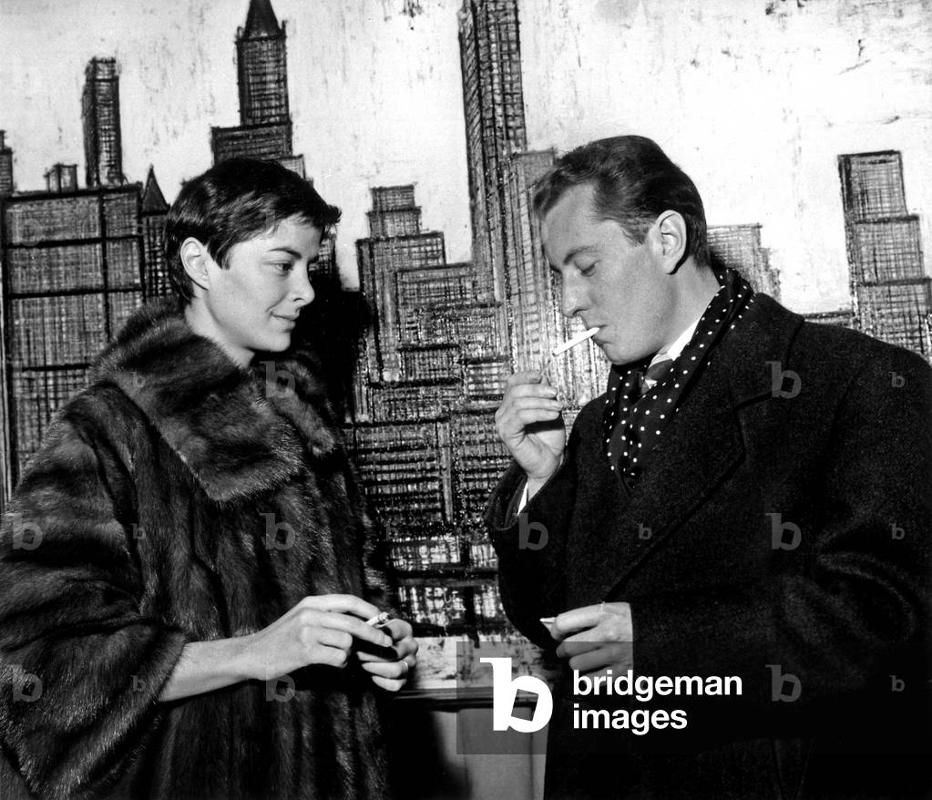 Bernard Buffet Is Showing To his Wife Annabel his Paintings About New York on February 4, 1959 in Paris (b/w photo)