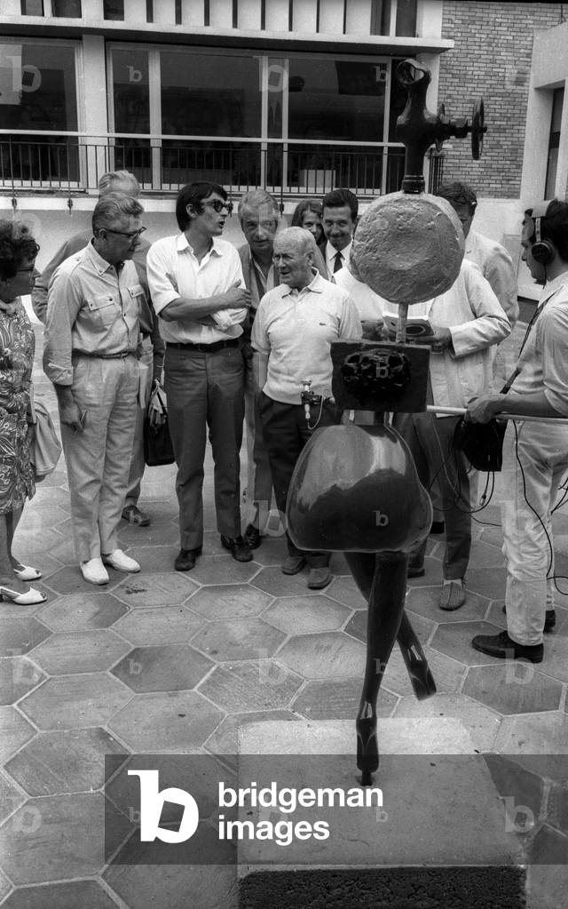 Joan Miro behind his 'modern woman' sculpture at the Maeght Foundation in Saint Paul de Vence where an exhibition of his work was organised for his 75th birthday, July 24, 1968