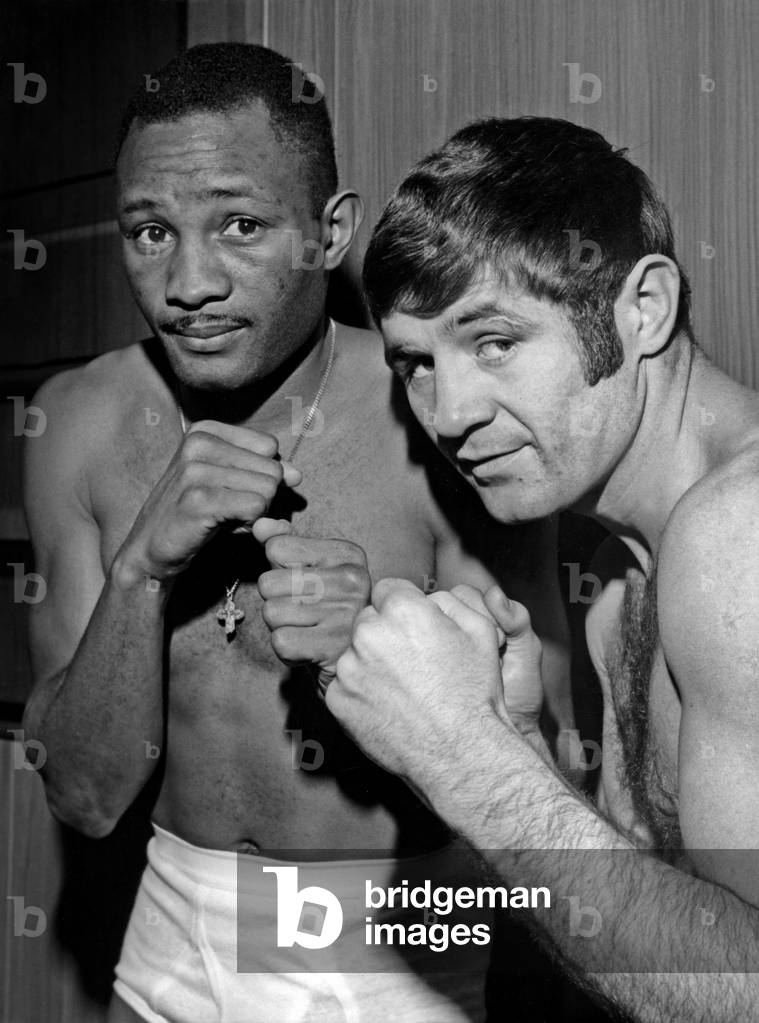 Jean Josselin (Right) And World Weight Champion Welters Curtis Cokes During Weighing Before Their Match At The Palace Of Sports At The Porte De Versailles On February 5, 1968 (b/w photo)