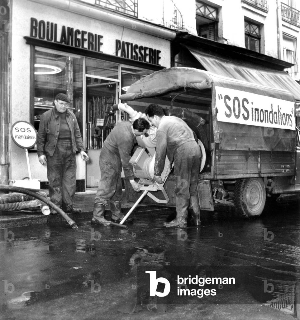 Floods in Paris : Equipment To Pump Out The Warter From Bakery Shop January 22, 1955 (b/w photo)