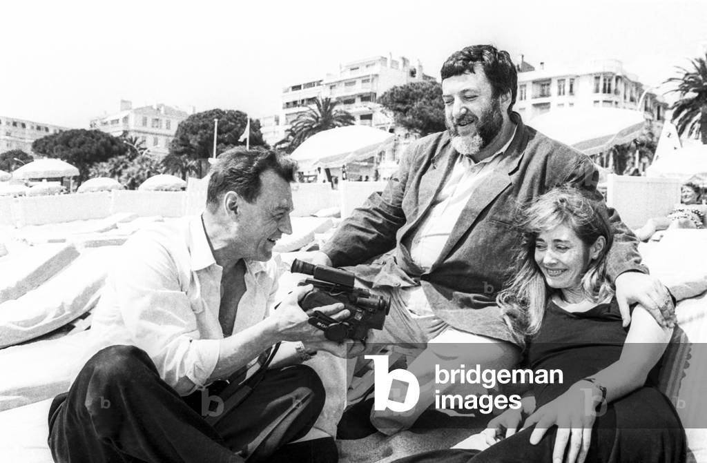Cannes film festival, May 15, 1990 :  Pavel Lounguine (c) with Piotr Zaitchenka and Natalia Koliakanova (b/w photo)