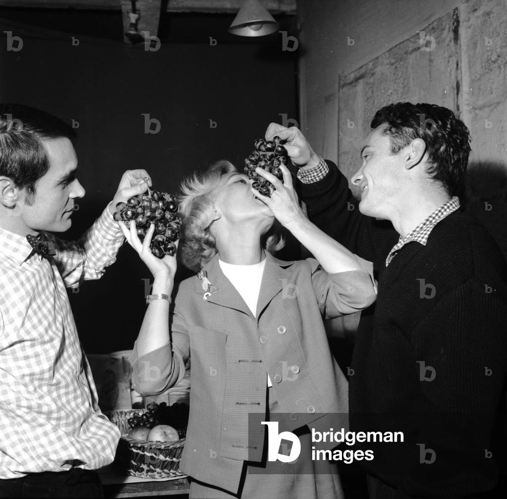 Actors Antoine Bourseiller, Daniele Delorme and Jean-Marie Fertey With Bunch of Grapes September 22, 1960 (b/w photo)