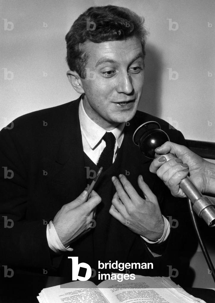 French Writer Bertrand Poirot-Delpech (1929 - 2006), Interallie Prizewinner With Journalists, Signing his Novel Le Grand Dadais, December 8, 1958 (b/w photo)