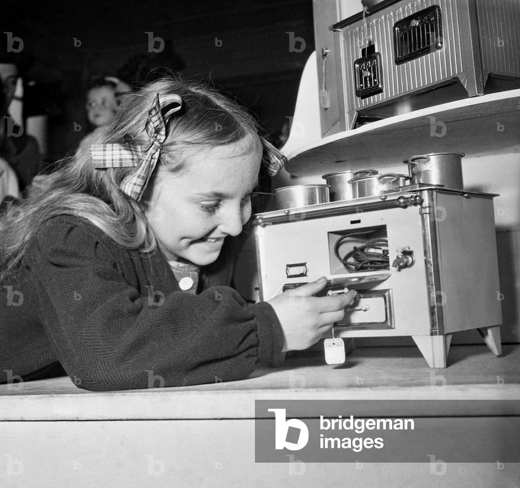 Girl Playing With A Doll'S Tea Set, at Time of Christmas, Paris, December 1948 (b/w photo)