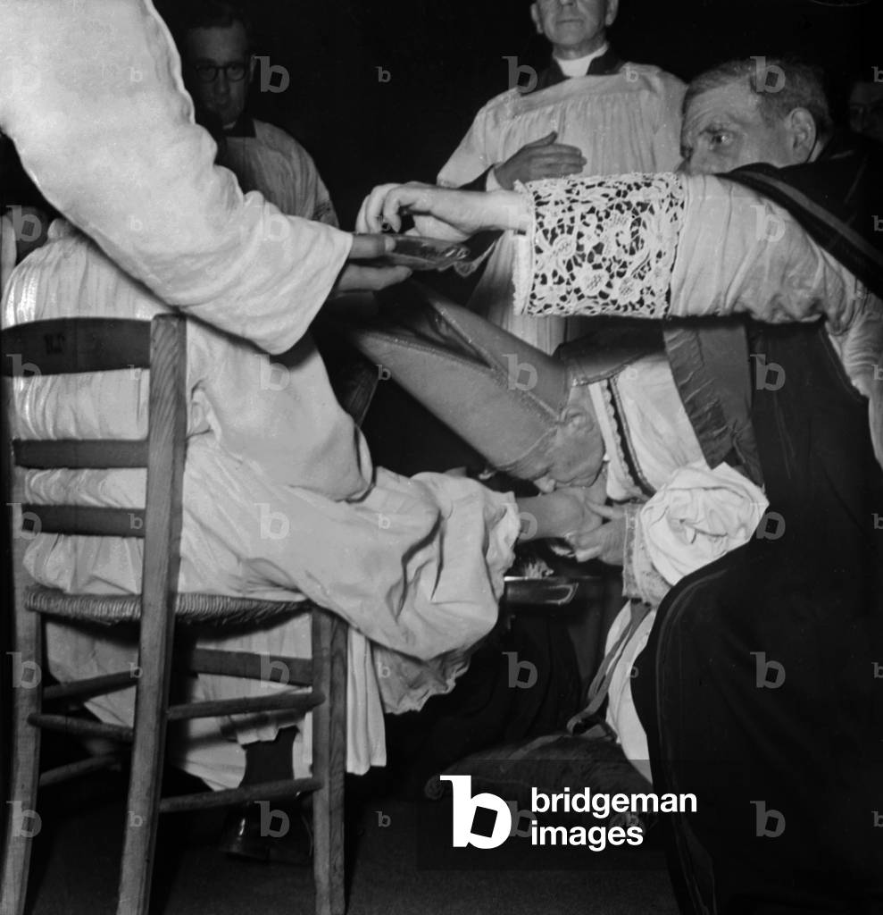 French Cardinal Emmanuel Suhard, Archbishop of Paris, during The Ceremony of Foot Washing, April 5, 1947 (b/w photo)