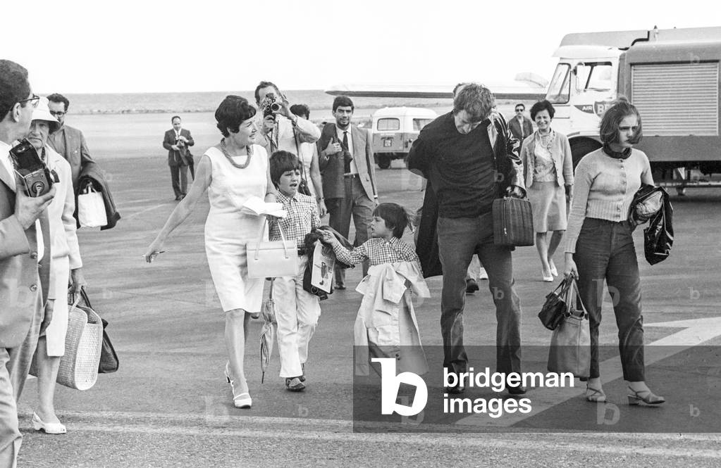 French actor Jean Paul Belmondo and his three children arriving at Nice airport for holidays on August 16, 1967 (b/w photo)