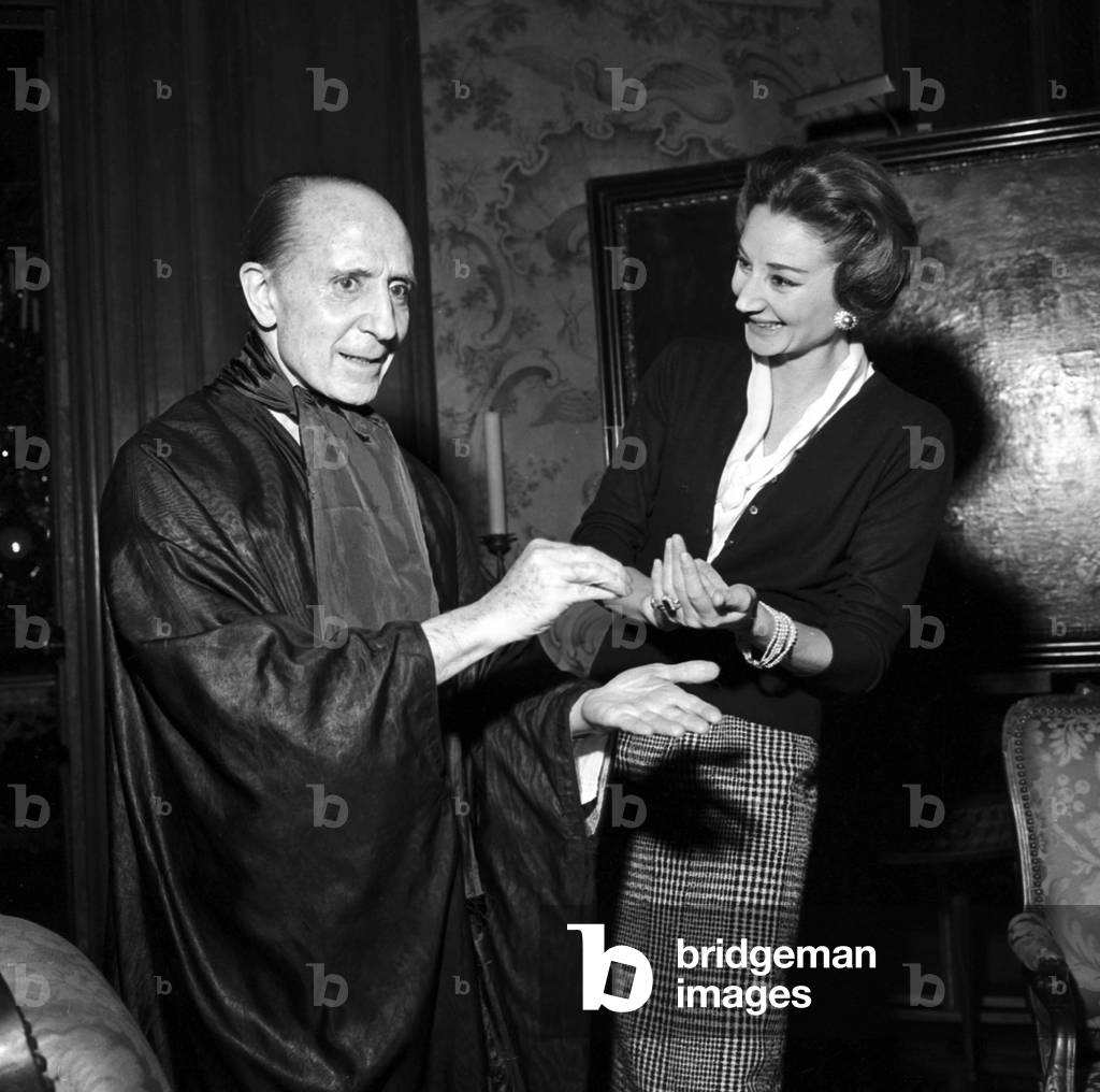 Marquis of Cuevas giving some advice to his friend Viscountess Jacqueline of Ribes for the choice of dances she will present, Paris, October 26, 1957 (b/w photo)