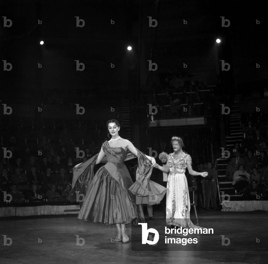 Fashion By Alwyne Camble in Medrano Circus on October 19, 1953 : here Model Maggy Sarragne With Clown Charlie (b/w photo)