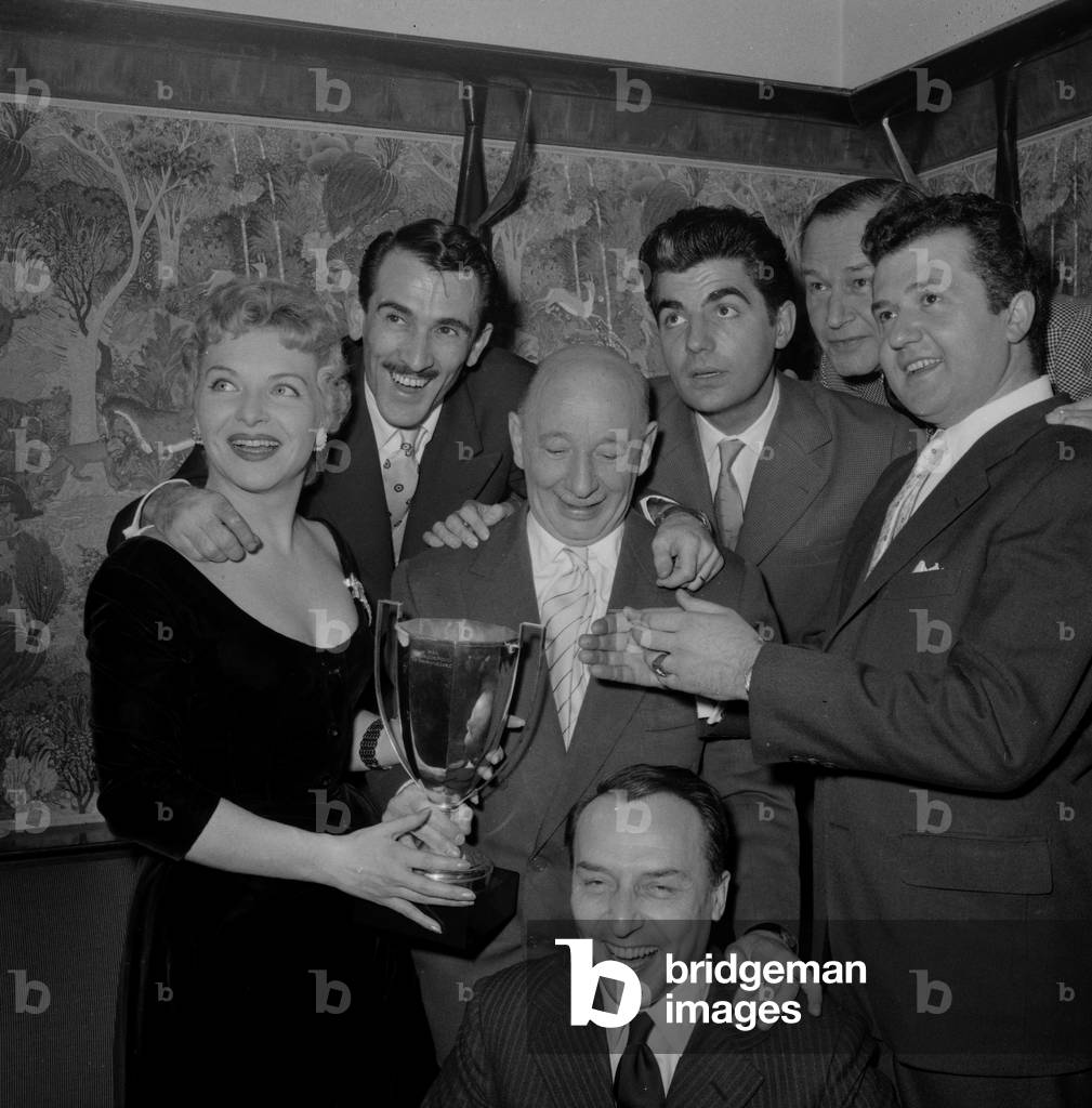 French singer, actress and revue leader Line Renaud, French scriptwriter Jacques Robert, French director Jean Boyer and French actors Roger Pierre and Jean Richard receiving the 'Coupe du Prestige' award for 'La Madelon' in Paris Elysees Club, on November 29, 1955
