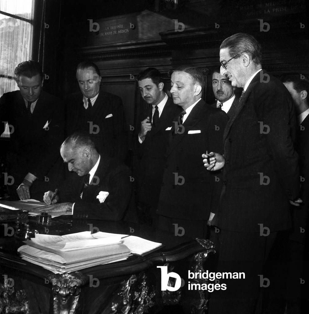 Signature of Aerial Agreement Between France and Brazil in Paris on January 27, 1947 : Frederico De Castelo Branco Clark Signing Under Look of Georges Bidault and Jules Moch (b/w photo)