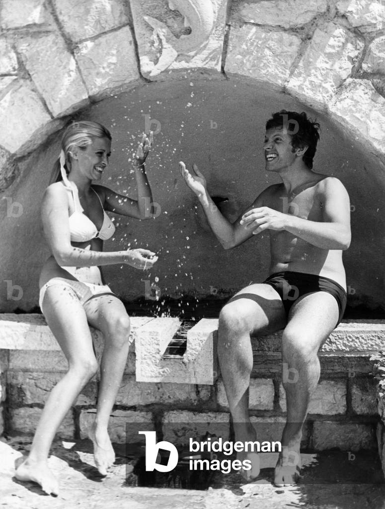 French Singer Frank Alamo and his Fiancee Sylvie Bouladou on Vacation. Antibes,Cote D'Azur, France, July 29, 1968 (b/w photo)