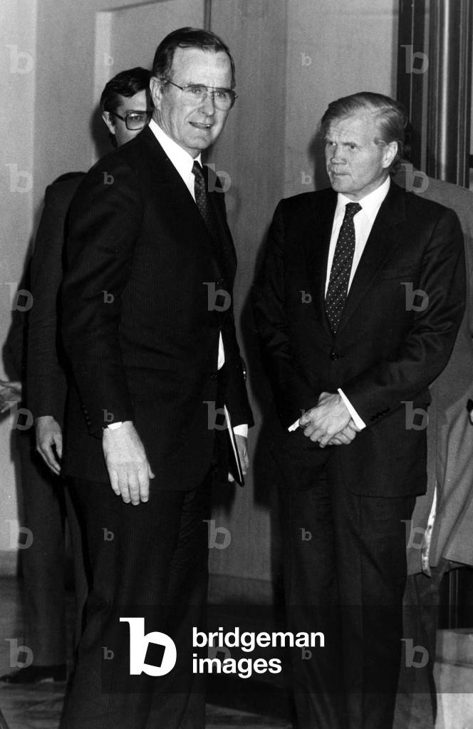Arrival By George Herbert Bush (Vice President of the United States) On Visit In Paris Arriving In The Elysee With Evan Galbraith (Ambassador of the United States), In France To Contain With The President Of The French Republic, February 16, 1984 (b/w photo)