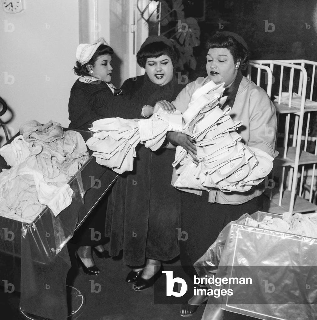 The Peter Sisters at opening of an establishment for automatic washing and ironing of men's shirts, Paris, February 14, 1952 (b/w photo)