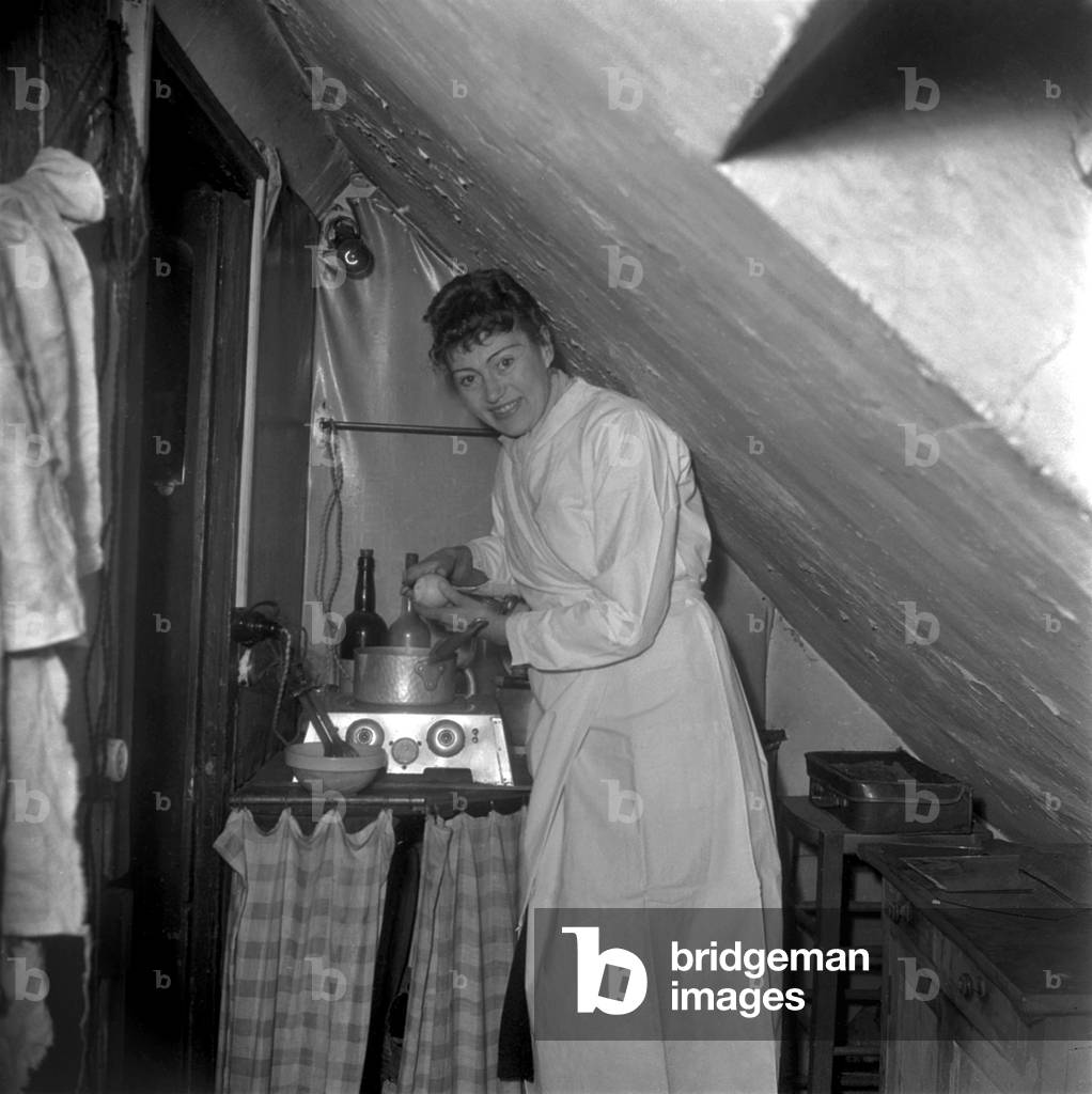 Woman Leaving in A Modest Place, in A Garret, Paris, March 25, 1948. Qhe'S Cooking With A Plate Warmer (b/w photo)