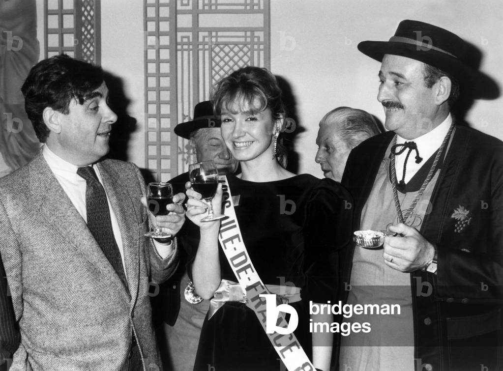 Bernard Pivot With Marie-Lise Allain (Miss Ile De France) and A Wine Beaujolais Friend in Paris on December 11, 1984 (b/w photo)