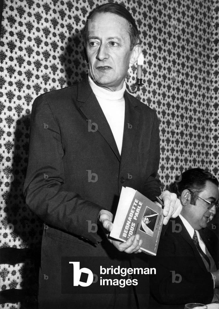 L'Abbe Laurentin A Lourdes Presented His Book “Bernadette Speaks You” On the occasion of the 114th Anniversary Of The Virgin's Apparitions To Bernadette Soubirous” February 14, 1972 (b/w photo)
