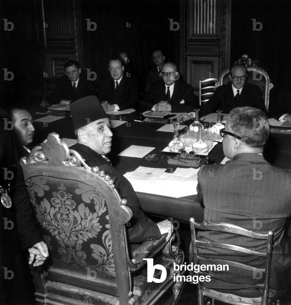 Meeting Between France and Tunisia in Paris : Christian Pineau, French Minister of Foreign Affairs, Guy Mollet, Head of French Government, Seydoux, Tahar Ben Ammar, Tunisian Prime Minister and Behi Ladghamn, Tunisian Minister, on February 29, 1956 (b/w photo)