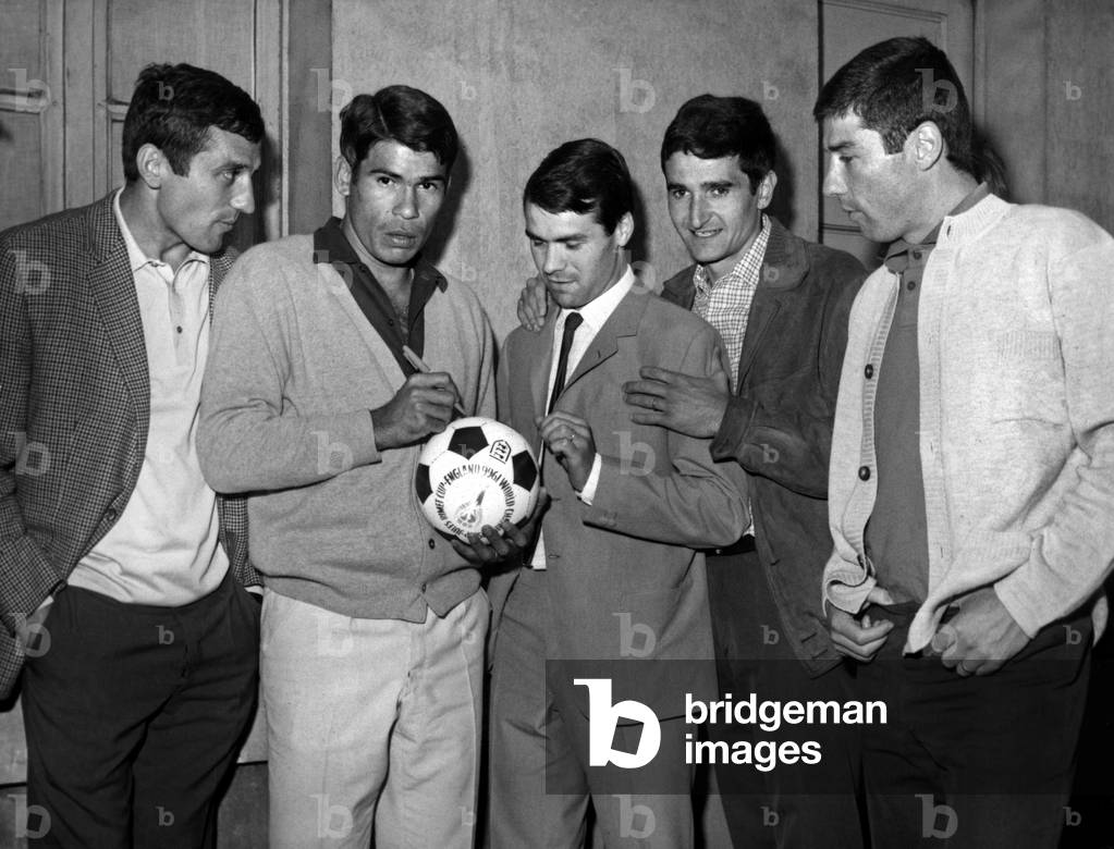 At the headquarters of the French Football Federation in Paris French Footballers Selected for Football World Cup Matches in England Applying Their Autographs To A Left To Right Ball Aubour, Combin, Baraffe, Carnus And Demichel June 21, 1966 (b/w photo)