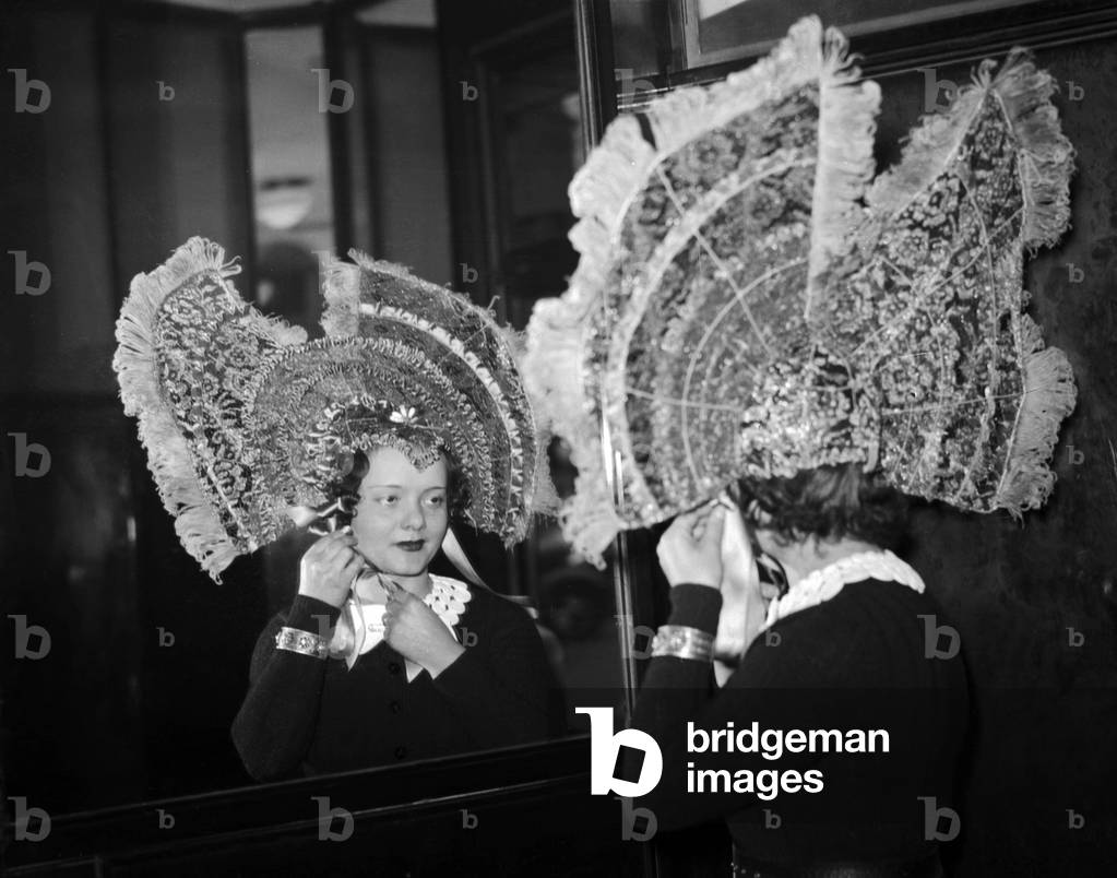 Young Woman in France in November 1937 on Saint Catherine Day : Holiday Made For Women Who Reach 25 Years of Age Without Marrying Which Symbolized Their Spinsterhood They Wore Unusual Hats To Show Their Status (b/w photo)