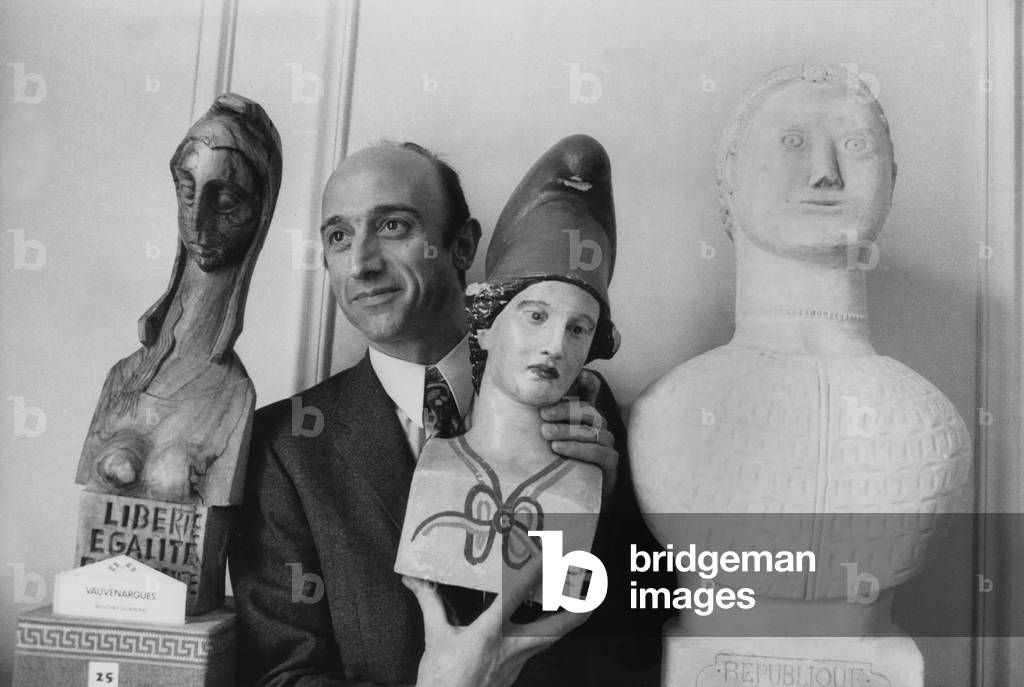 Pierre Bonte Posing With Three Busts of Marianne (Female Figure Personifying The French Republic) : L-R The One of Vauvenargues Townhall (Bouches Du Rhone Department), The One of Sauzet Townhall (Drome Department), Et The One of Courleon Townhall (Maine Et Loire Department) February 17, 1972 in Paris (b/w photo)