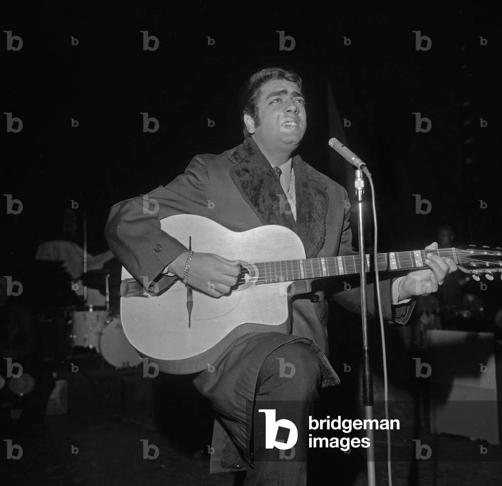 French singer Enrico Macias with his guitar during his concert's rehearsal at the Olympia, on October 31, 1966