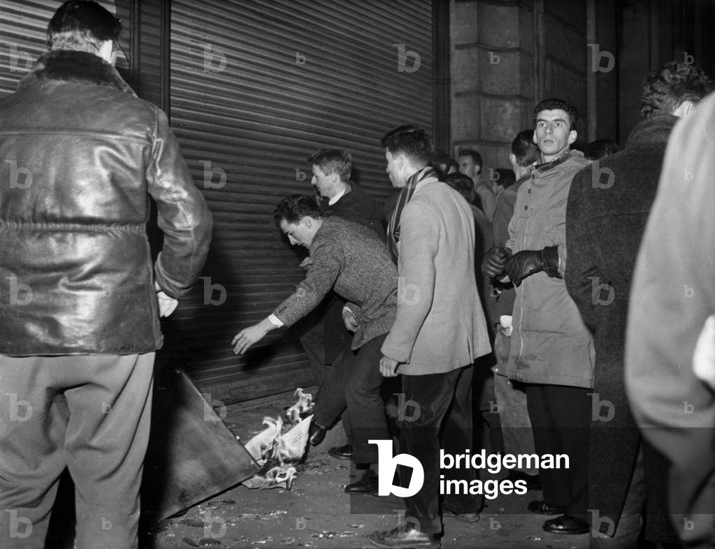 French Students Demonstrating in Front of The Building Hummanite .Here, Demonstrators Trying To Burn The Building, in Paris, November 6, 1956 (b/w photo)