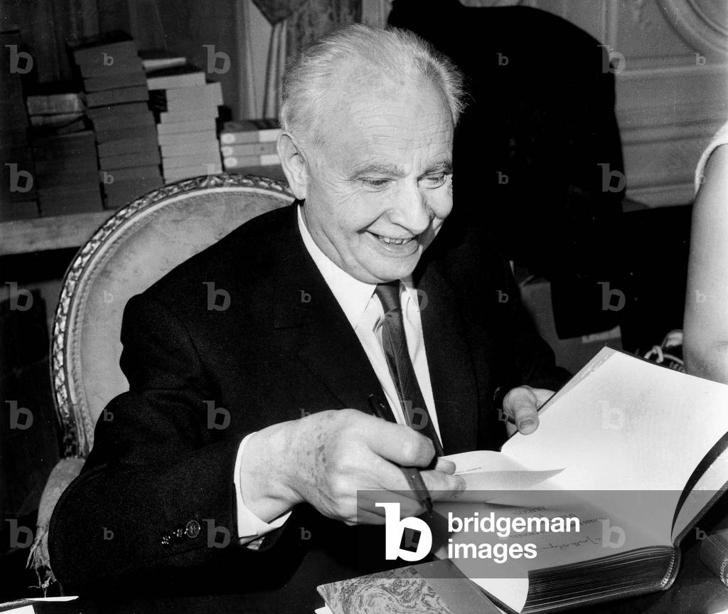 French Writer Louis Aragon Signing One of his Book November 30, 1968 (b/w photo)