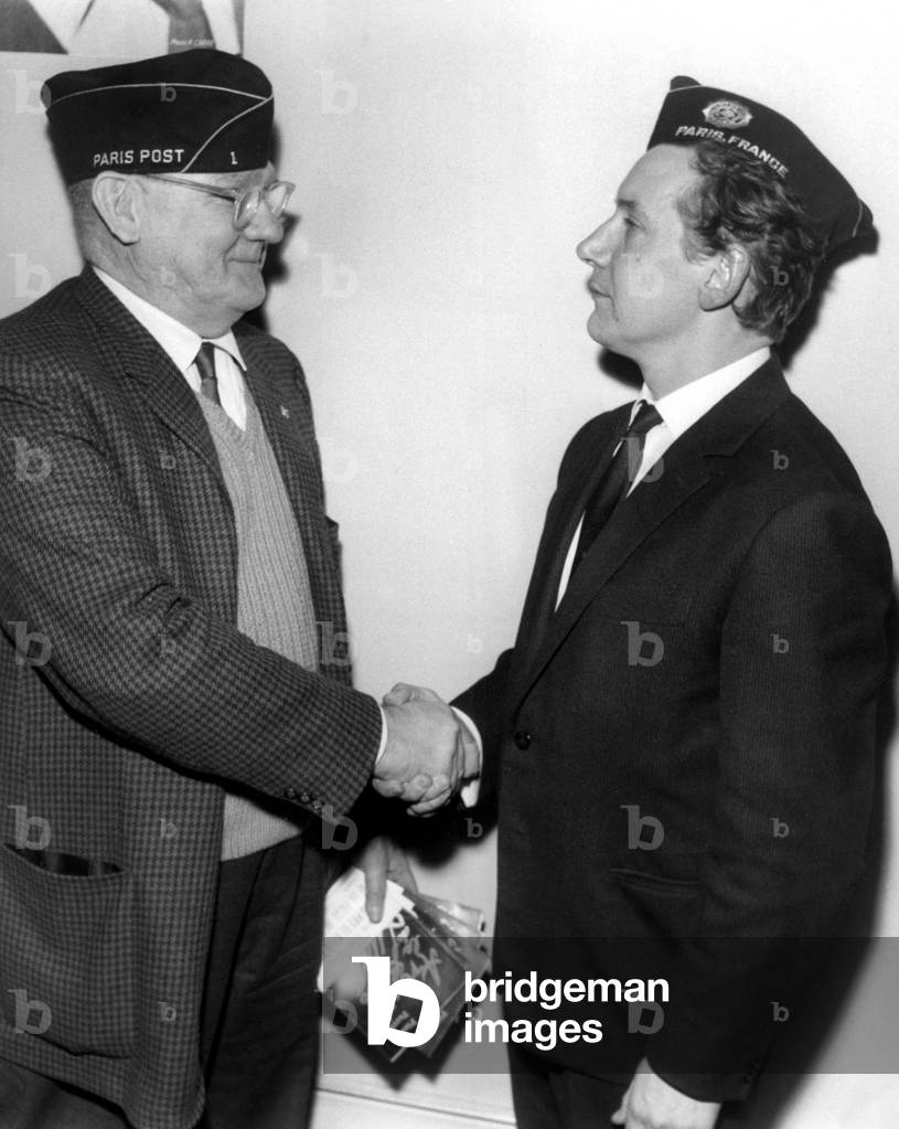 Pierre Perrin Coat of the Traditional Calot (Right) Honorary Member of the American Legion at a Ceremony at the Headquarters of the Association Rue Pierre-Charron Felicite By Colonel Howard C. Dullin President of the American Legion April 10, 1963 (b/w photo)