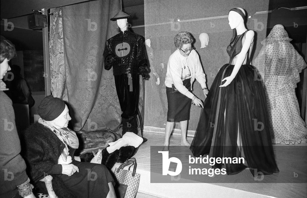 On the eve of the opening of the exhibition “De Main De Maitre” Madame Gres puts the last hand to the dress of her creation from her collection at the Salon des Metiers d'Art at the Grand Palais in Paris on February 5, 1988. Neg: Cx20575 (b/w photo)