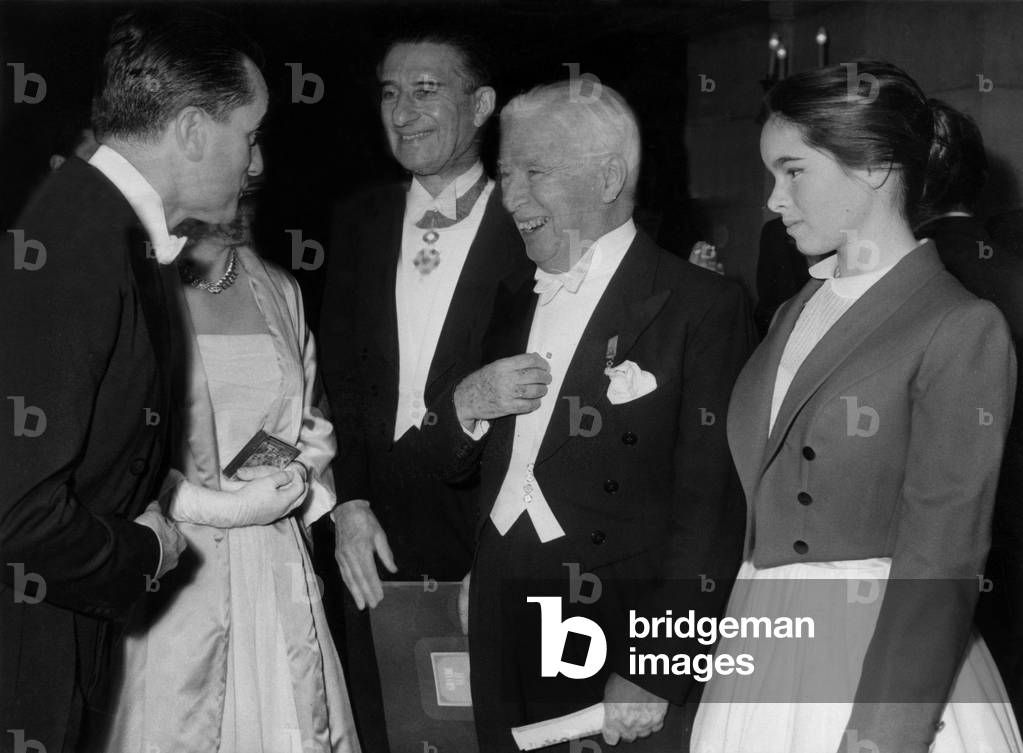December 20, 1958, Gala at Paris Opera House : on L : Jacques Chaban-Delmas and his Wife Marie Antoinette Geoffroy Saluting Charlie Chaplin and his Daughter Geraldine, in The C : Paul Louis Weiller (b/w photo)
