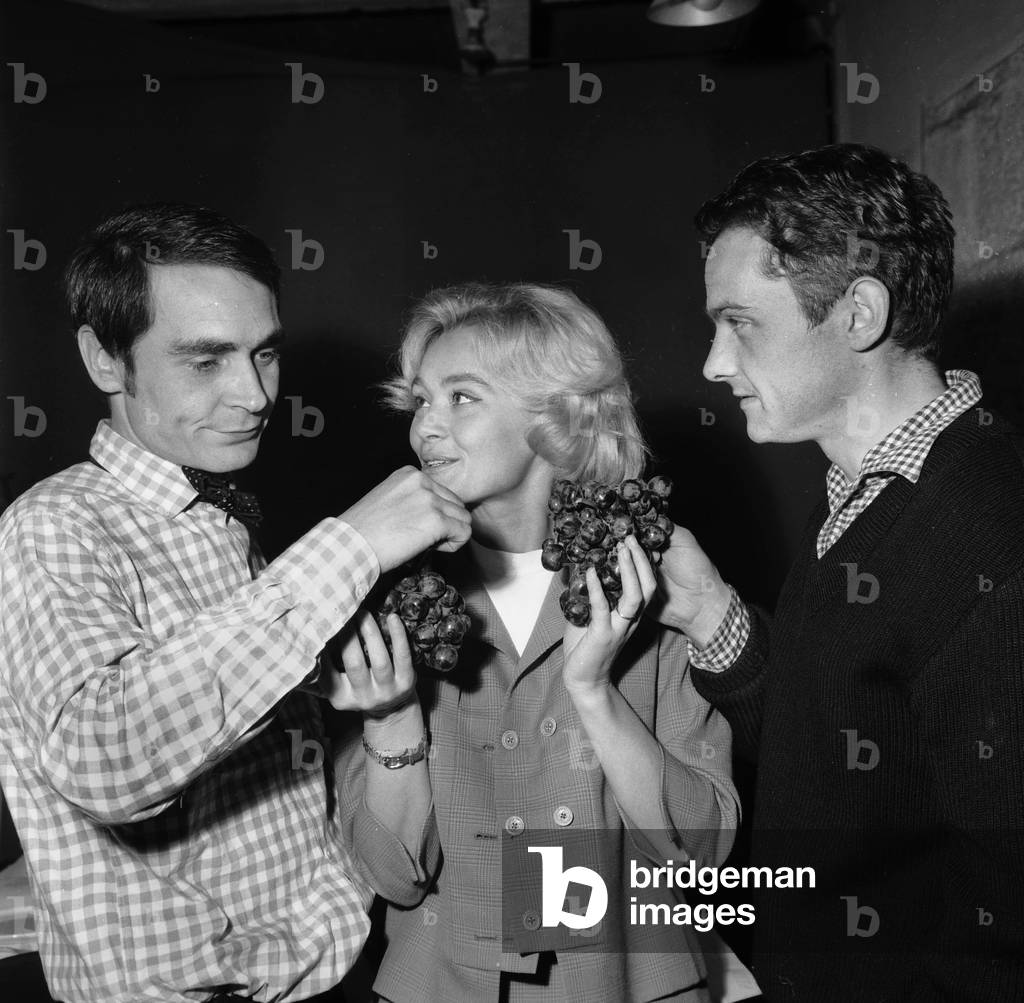 Actors Antoine Bourseiller, Daniele Delorme and Jean-Marie Fertey With Bunch of Grapes September 22, 1960 (b/w photo)
