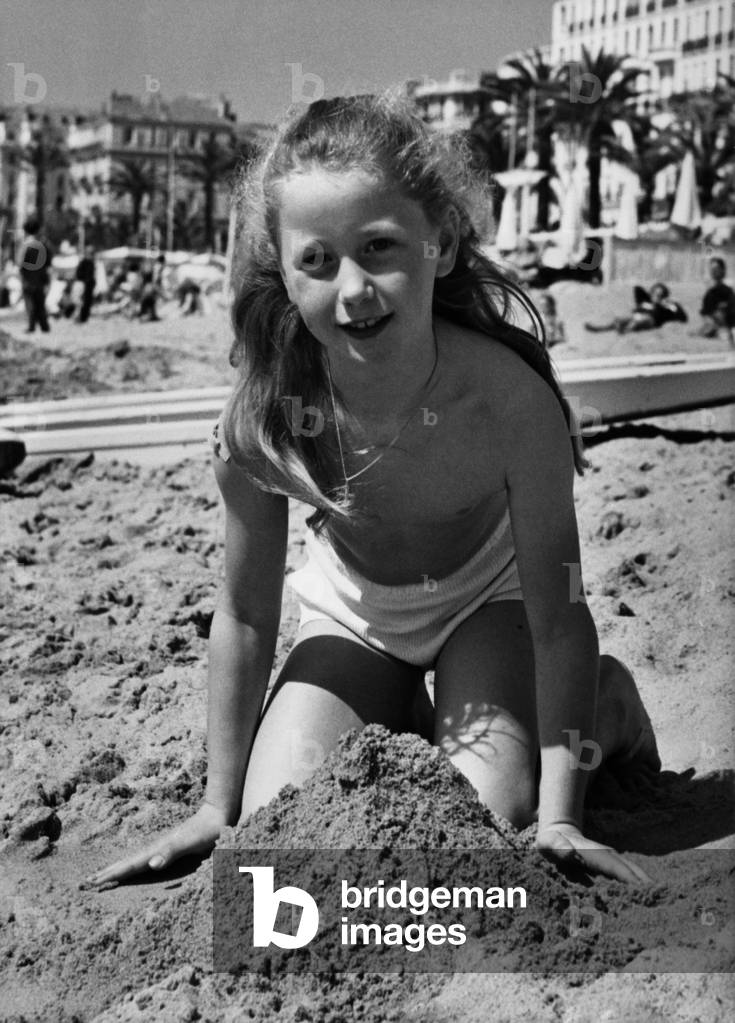 Young Actress Brigitte Fossey, on The Beach in Cannes, France, April 7, 1955 (b/w photo)