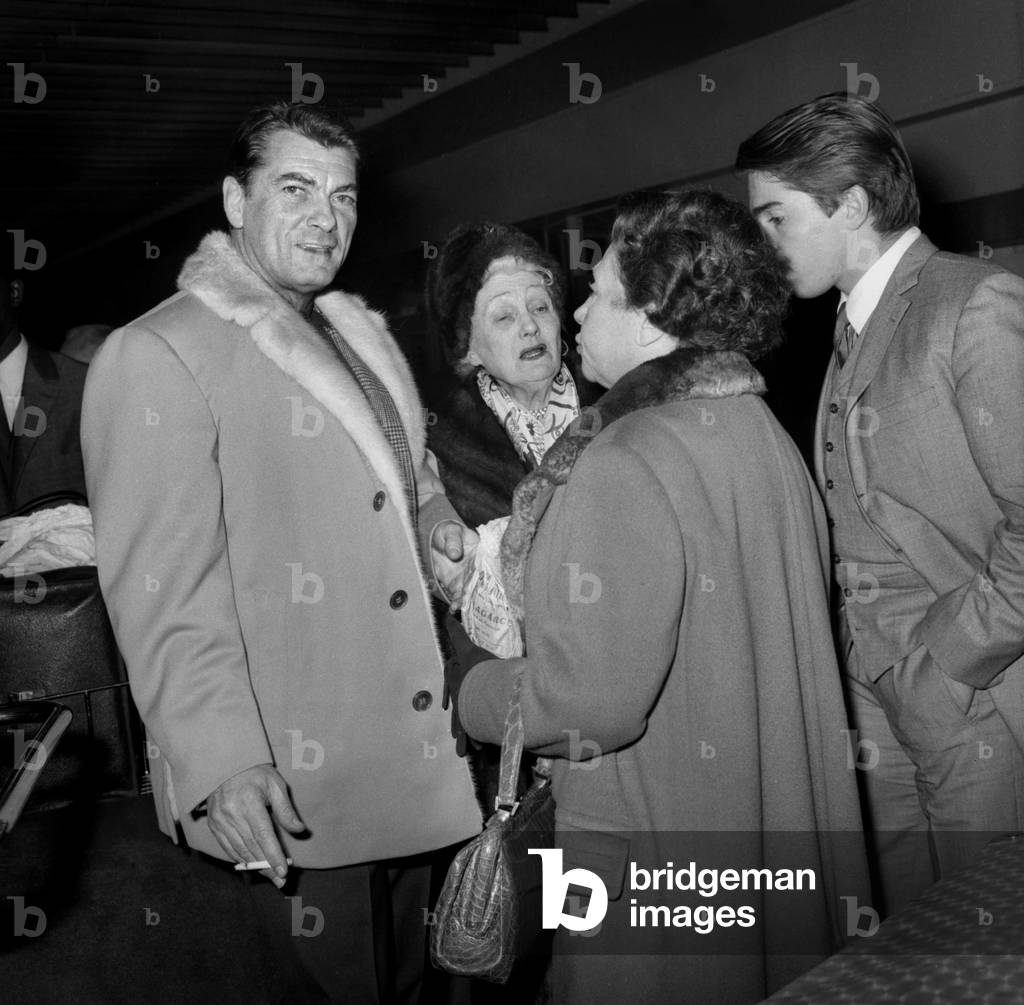 Jean Marais at Bourget Airport in Paris With his Mother Rosalie, his Agent and his Adoptive Son Serge Ayala, October 23, 1964 (b/w photo)