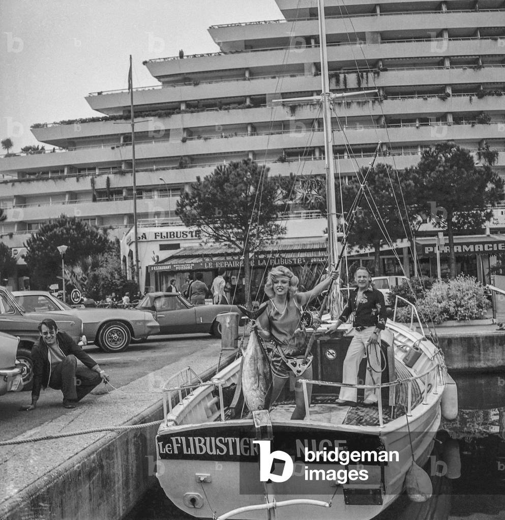 Brigitte Aube, former Mis France, showing a tuna in Nice, French Riviera, April 17, 1979 (b/w photo)