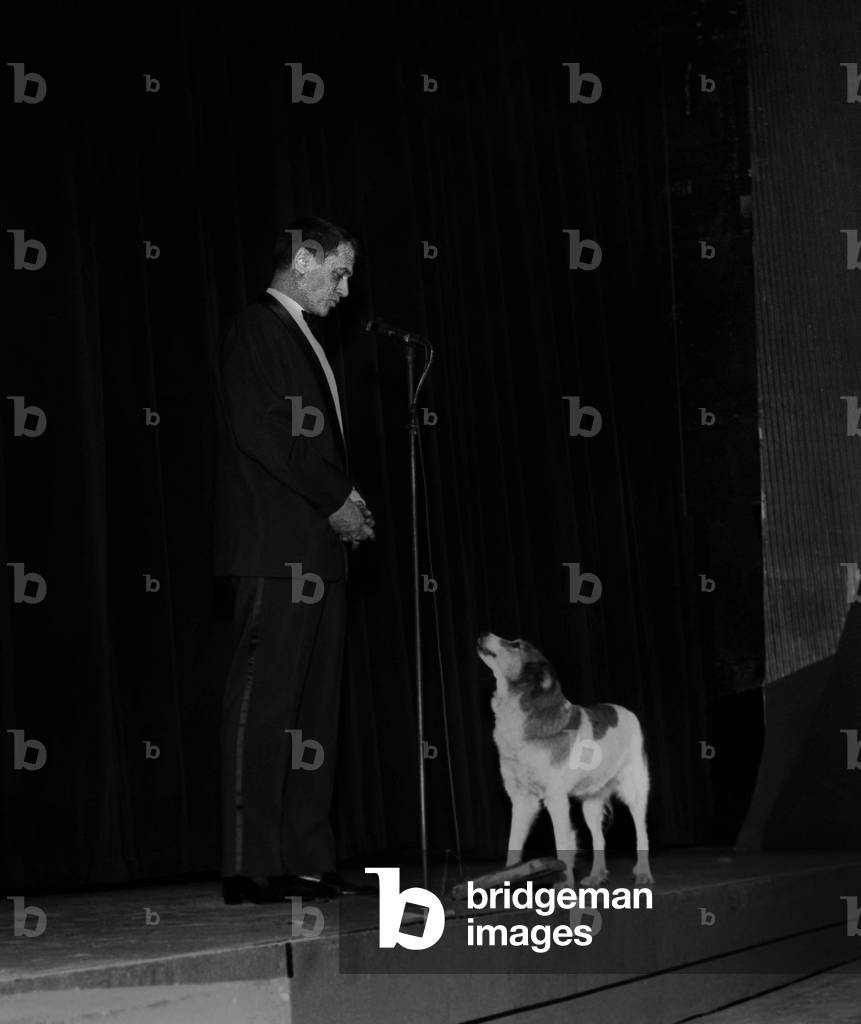Georges De Caunes with a dog at gala of March 1st, 1966, Paris (photo)