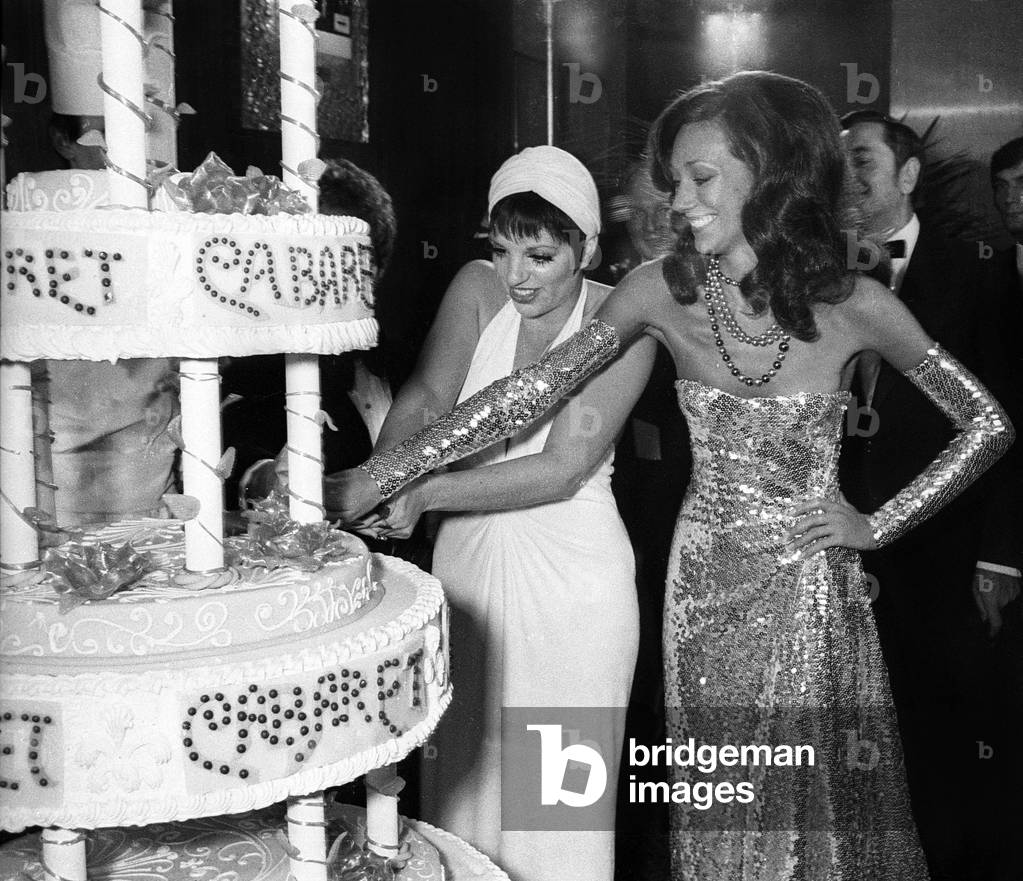 Liza Minnelli and Marisa Berenson cutting the cake after the Premiere of 