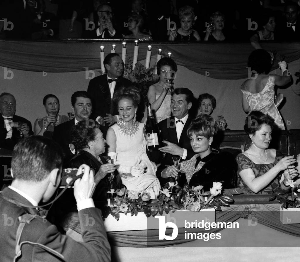 Jean Marais with a bottle of champagne (Taittinger) at the Gala of the Artists, Paris, 8 March 1963 (photo)