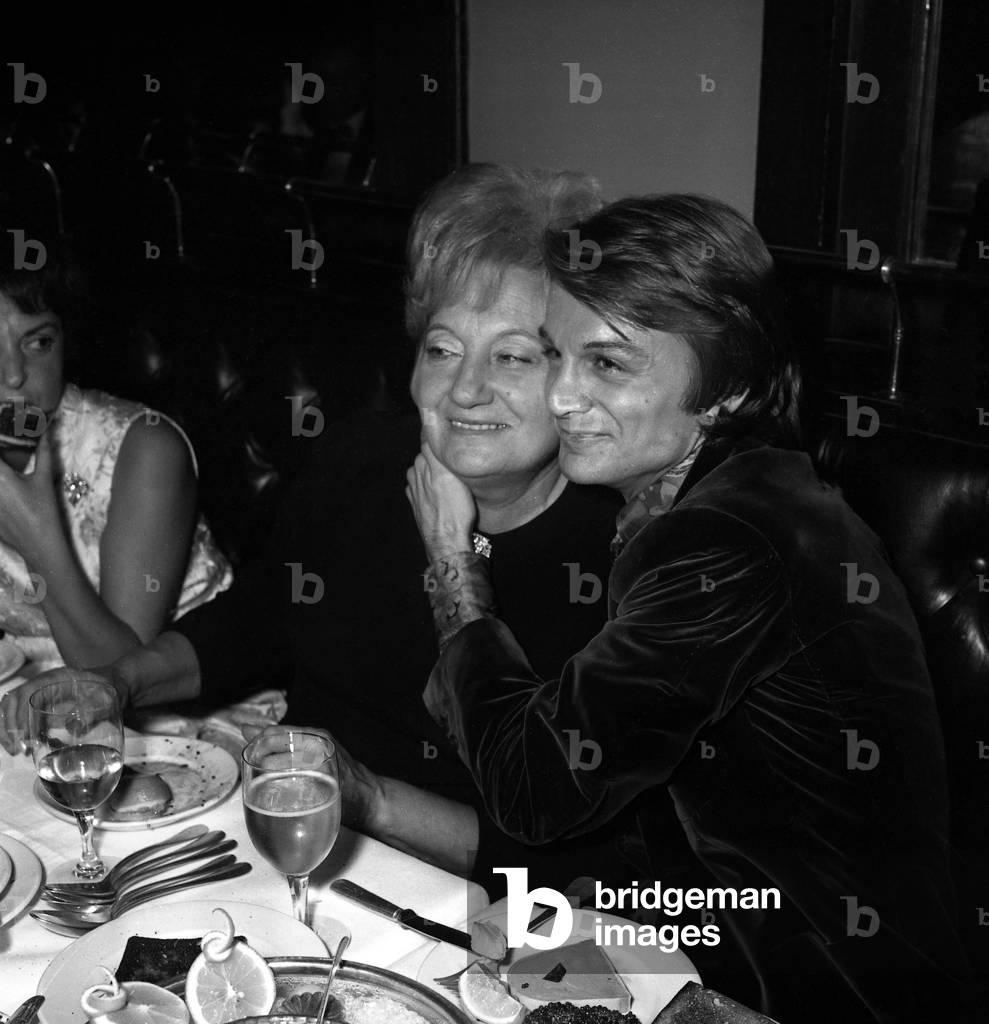 French Singer Claude Francois with his mother Lucie at a restaurant after his concert at the Olympia, Paris, November 1969  (photo)
