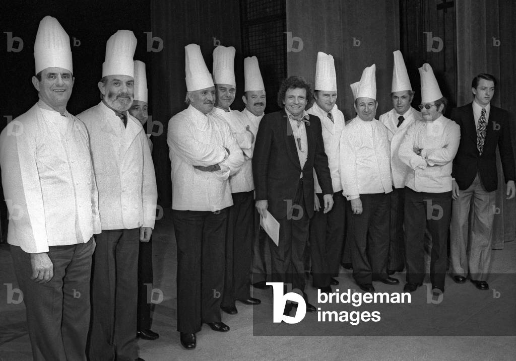 French cook Paul Bocuse visiting Jacques Martin at the Theatre des Varietes in Paris on February 26, 1975 : l-r : Paul Bocuse, Jean Troisgros, Roger Verge, ?, Pierre Troisgros, Jacques Martin (b/w photo)