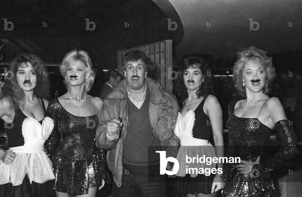 Stephane Collaro and his coco girls at a party given to celebrate the 40 years in showbusiness of the French Actor Moustache, Paris, 19 November 1985 (photo)