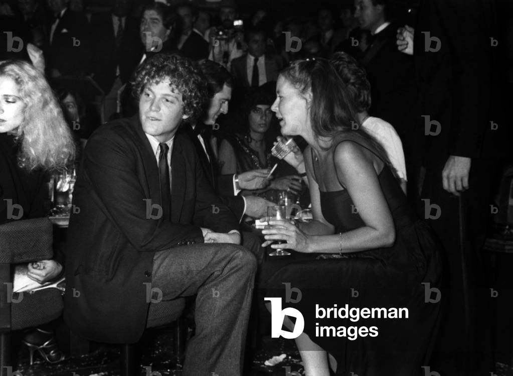 Teddy Kennedy (Son of Senator Edward Kennedy) Talking With Mora Hamilton (Woman of Photographer David Hamilton) On The First Anniversary Of The Apocalypse Club By Patrick And Gabrielle Leroy October 15, 1981 (b/w photo)