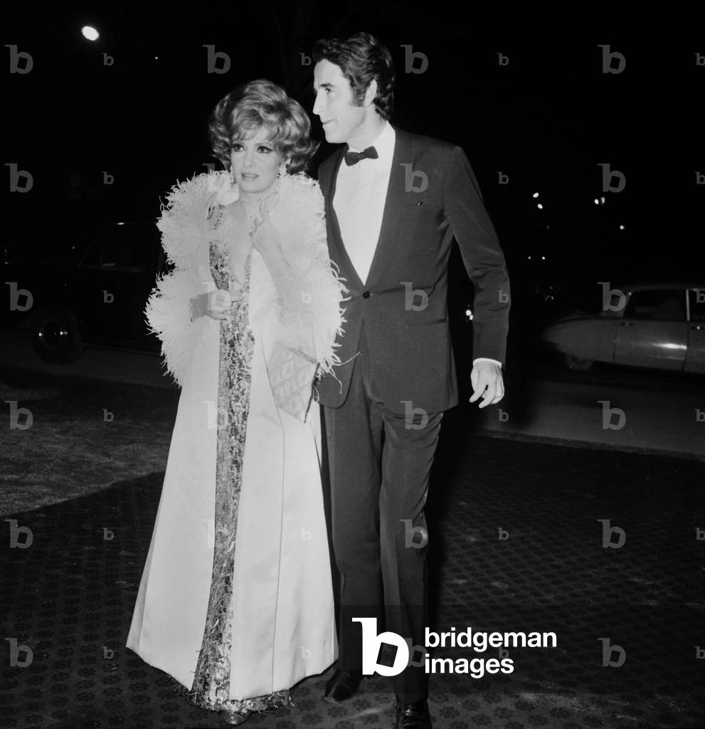 Gina Lollobrigida and Jacques Chazot arriving at the Premiere of the film 